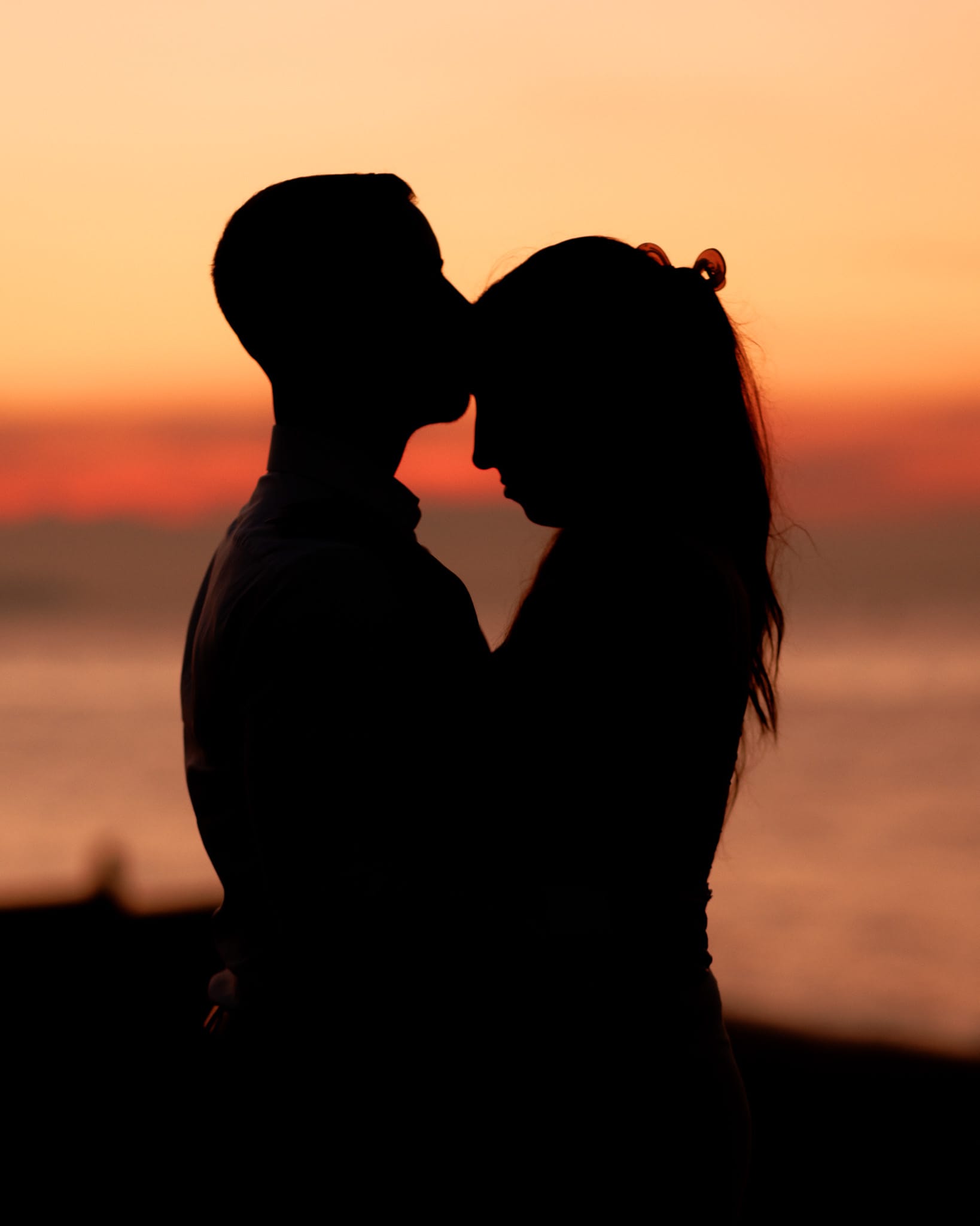 An engaged couple on a beach in Kent at sunset