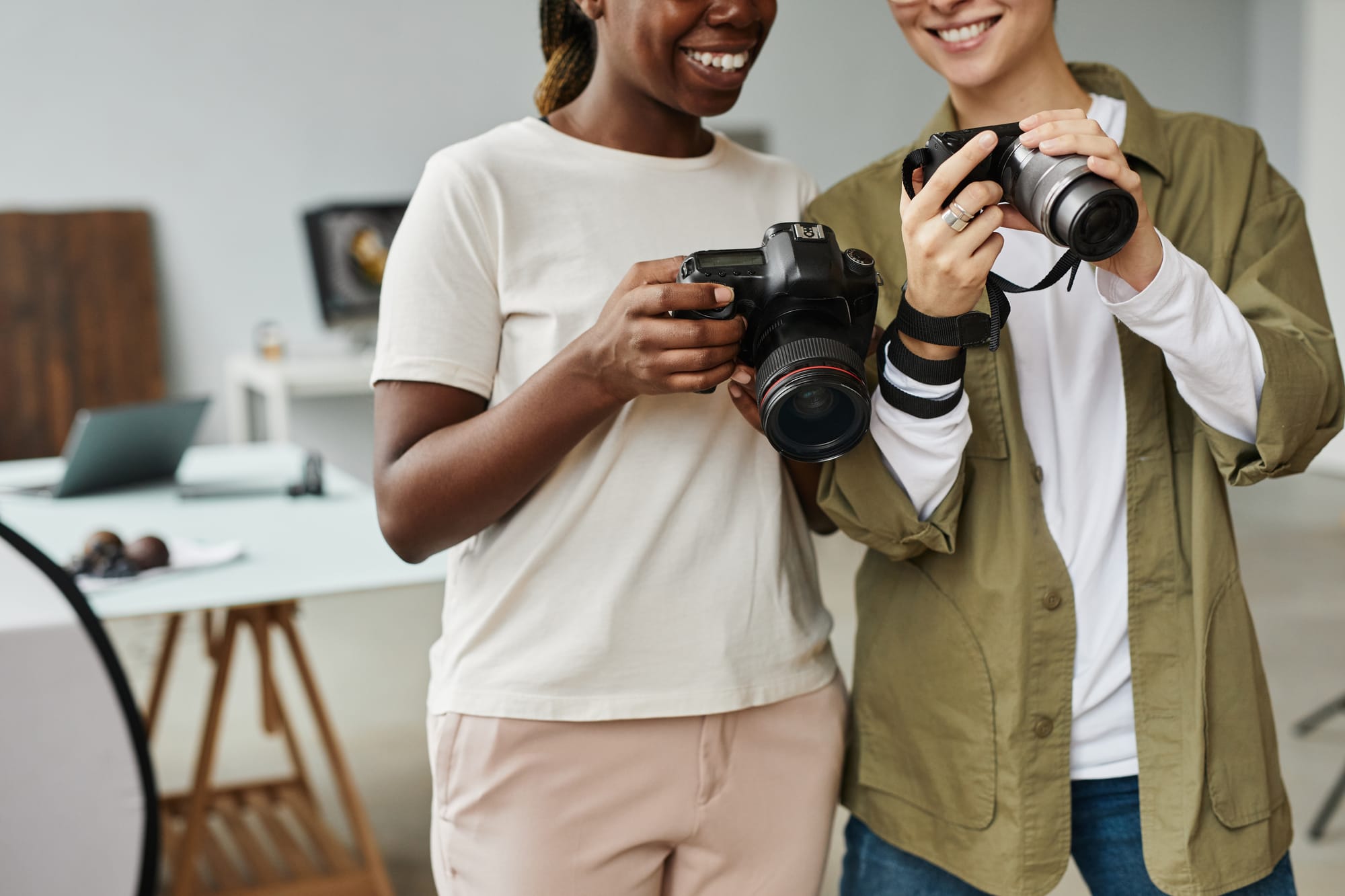 2 photographers looking at their professional cameras